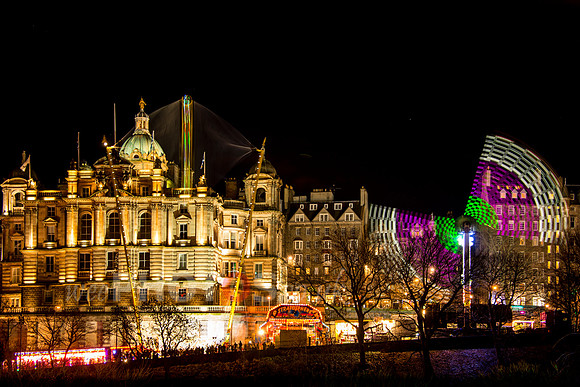 Edinburgh's Christmas funfair with the Bank of Scotland building on the Mound